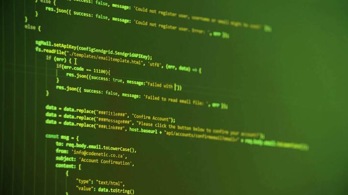 JSON code screen - Close-up of computer screen displaying lines of code in green and ...